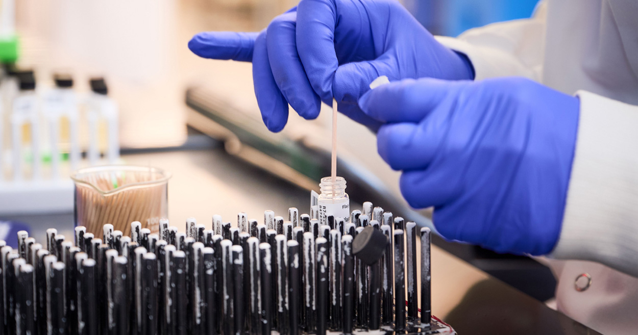 A woman picking a stab in the lab.